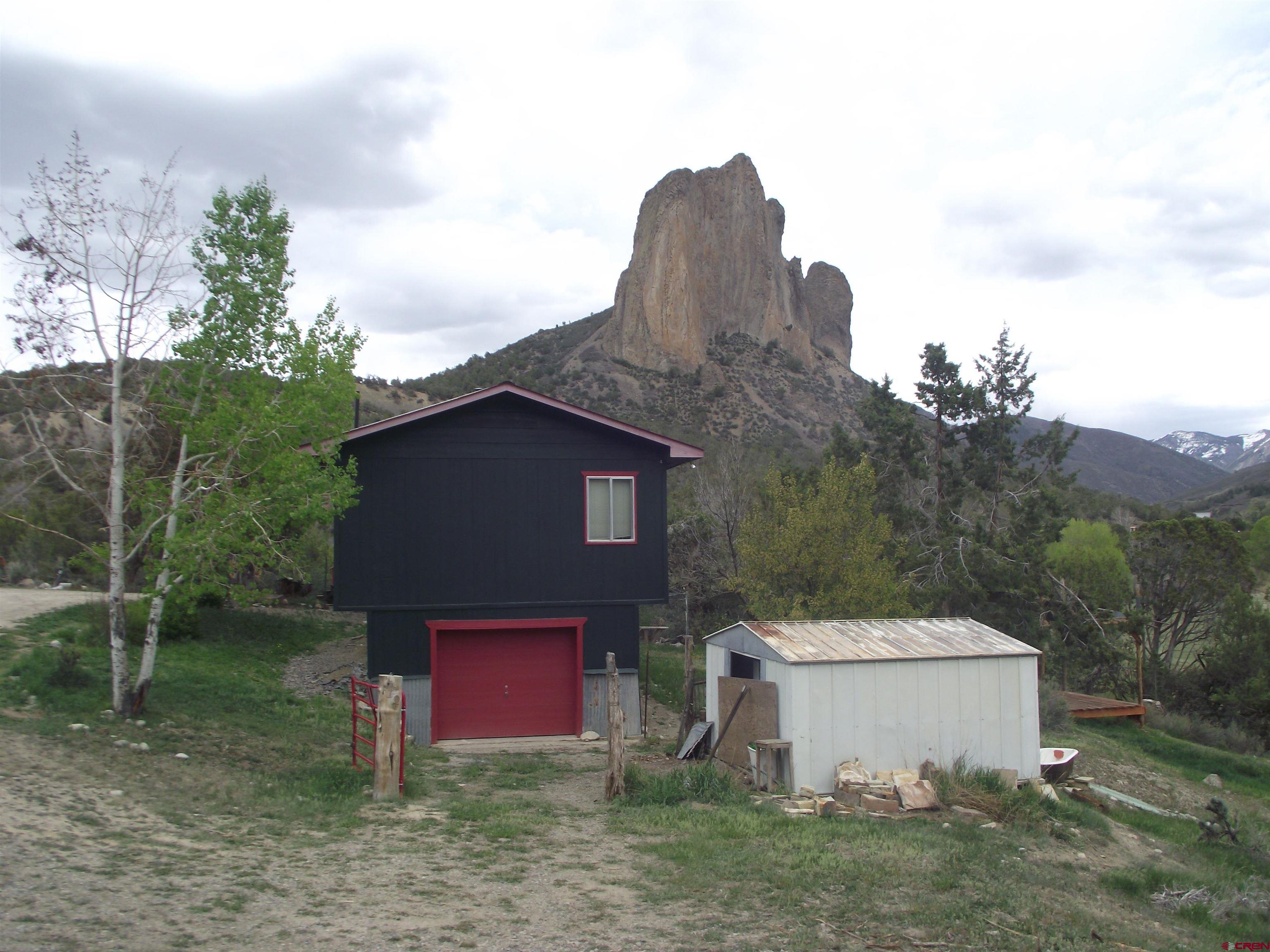 42996 Needle Rock Road Crawford, CO 81415 - Photo 14 of 45 a view of a small house with a yard