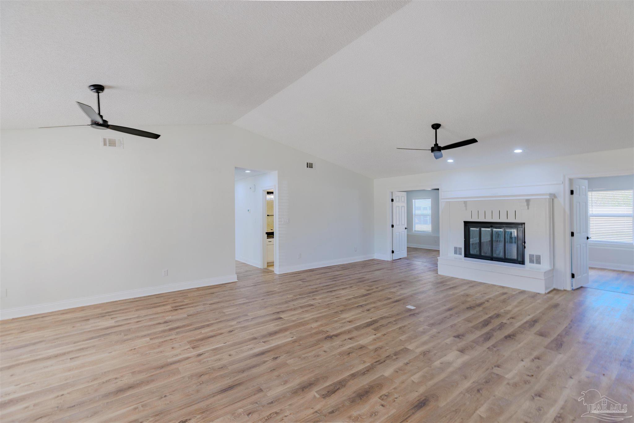 2115 Stallion Road Cantonment, FL 32533 - Photo 18 of 70 a view of an empty room with a fireplace and a window