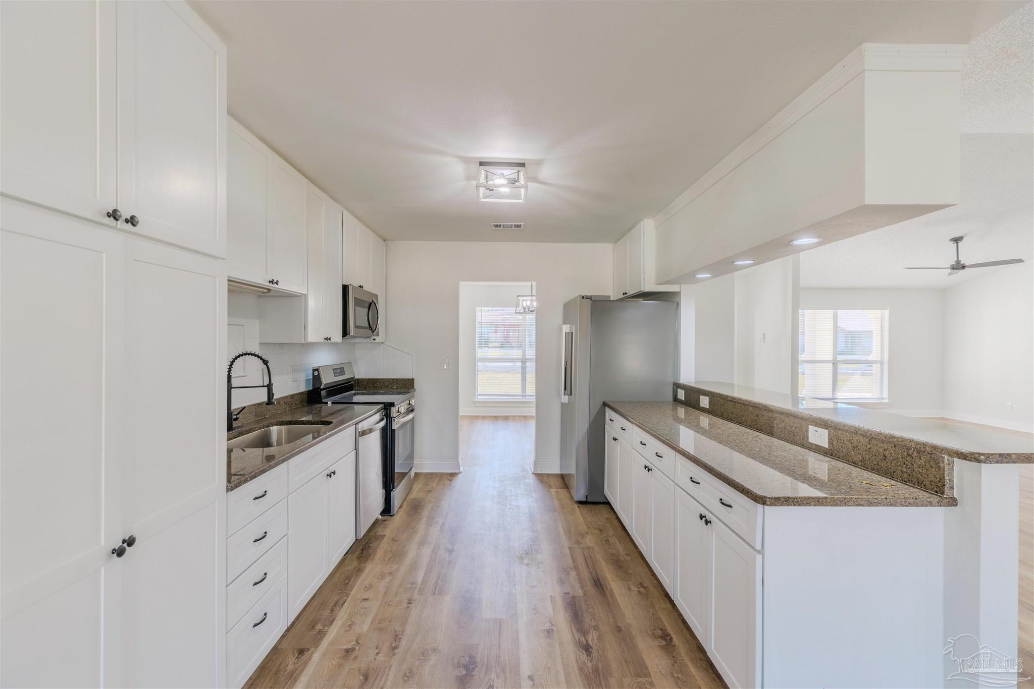 2115 Stallion Road Cantonment, FL 32533 - Photo 20 of 70 a large kitchen with a stove top oven