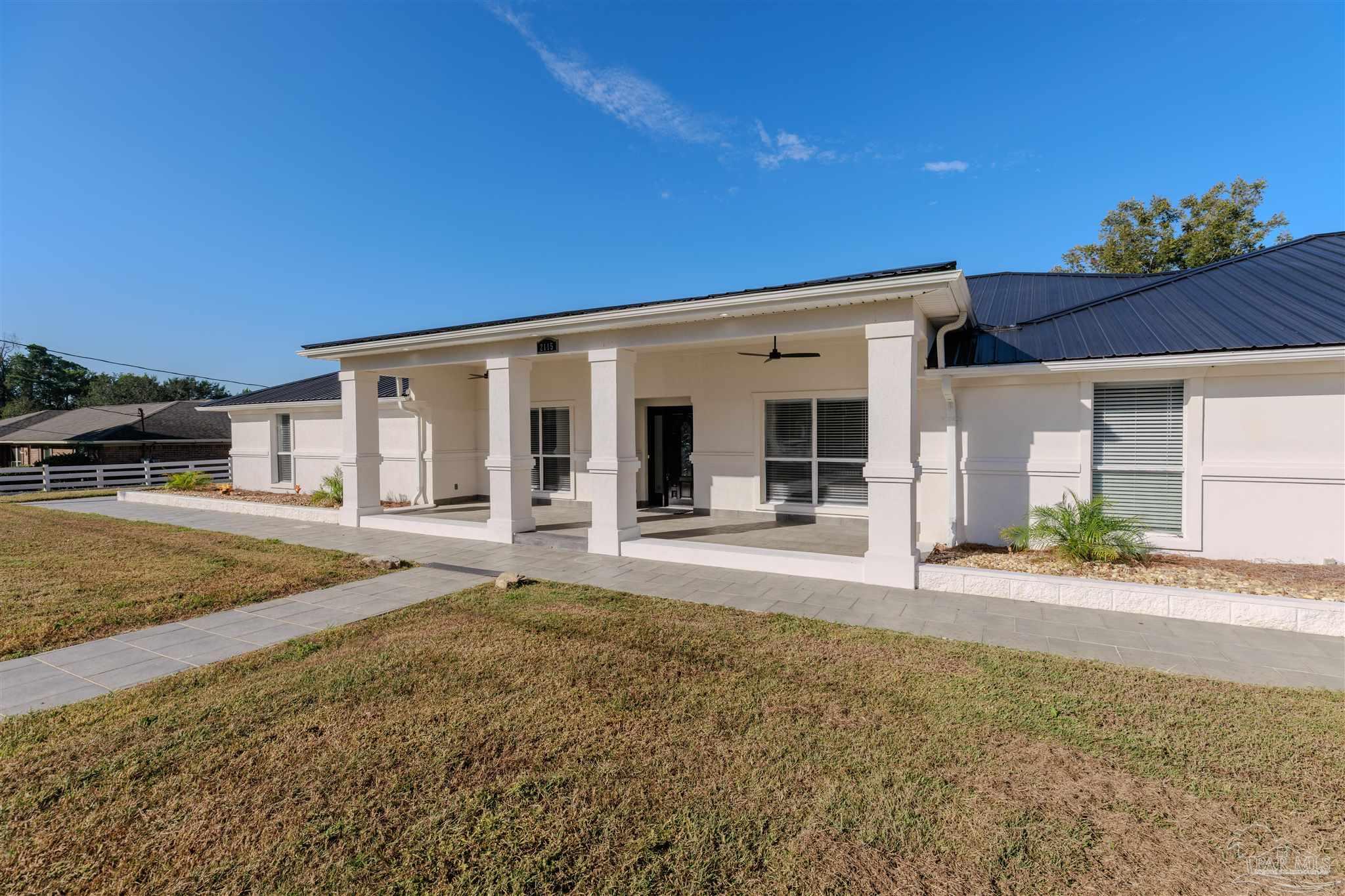 2115 Stallion Road Cantonment, FL 32533 - Photo 2 of 70 a view of a house with a patio