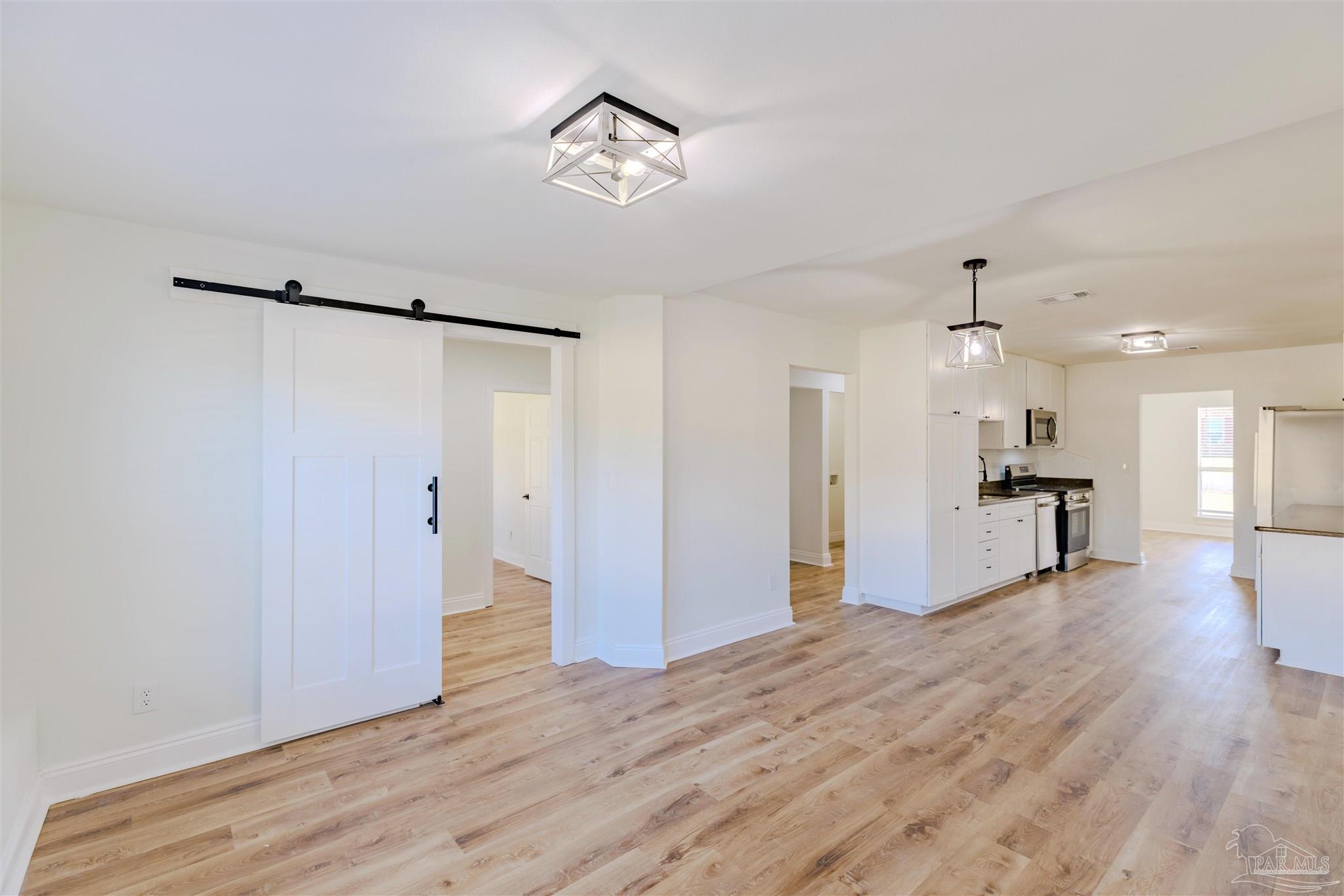 2115 Stallion Road Cantonment, FL 32533 - Photo 24 of 70 a view of a kitchen with wooden floor and a ceiling fan