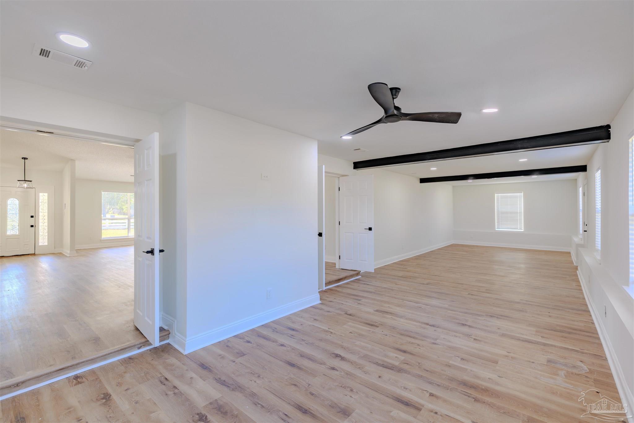 2115 Stallion Road Cantonment, FL 32533 - Photo 27 of 70 a view of a livingroom with wooden floor and a ceiling fan