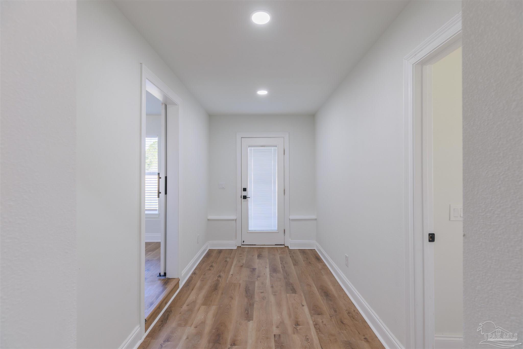 2115 Stallion Road Cantonment, FL 32533 - Photo 41 of 70 a view of a room with wooden floor and a hallway