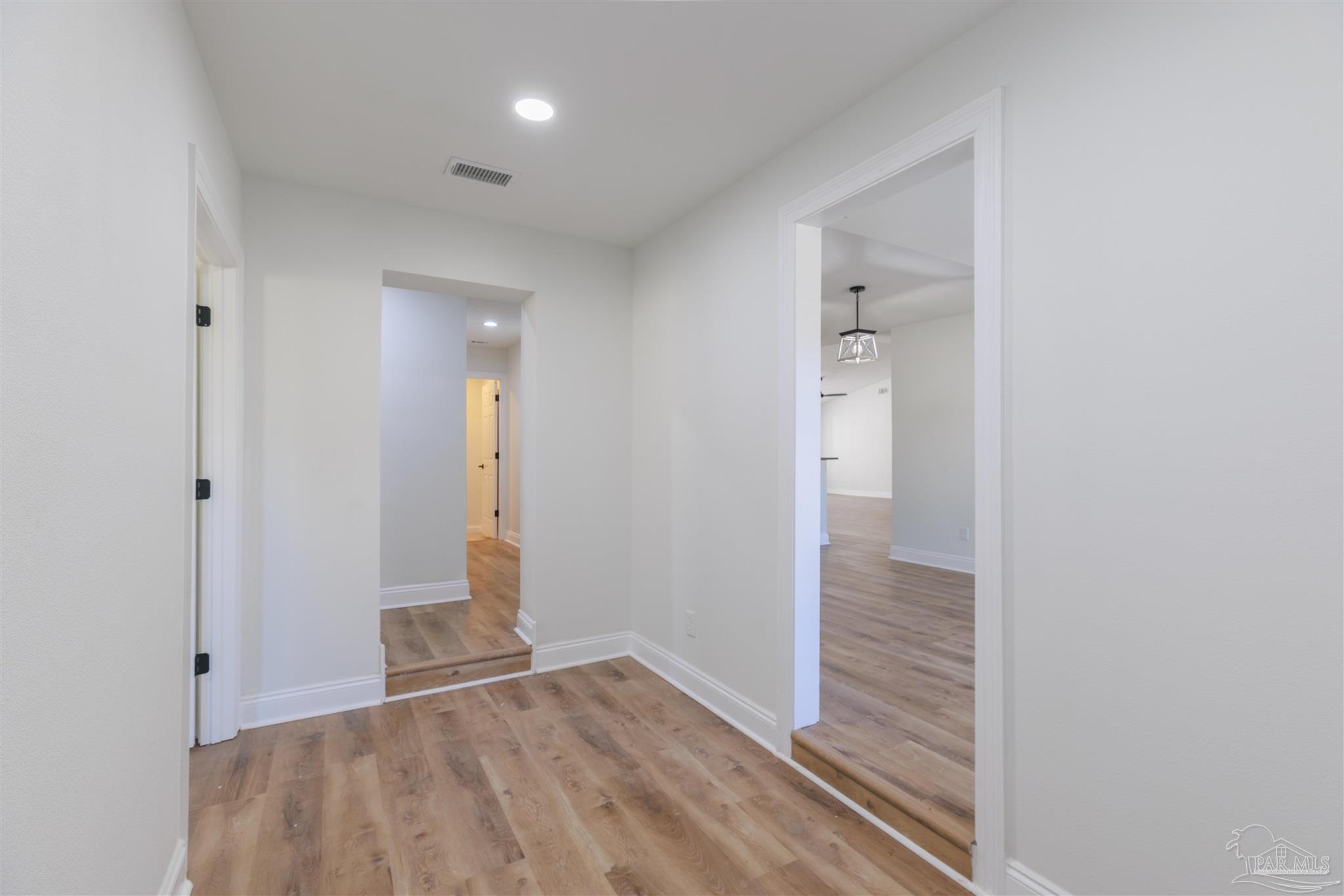 2115 Stallion Road Cantonment, FL 32533 - Photo 42 of 70 wooden floor in a hall with an entryway