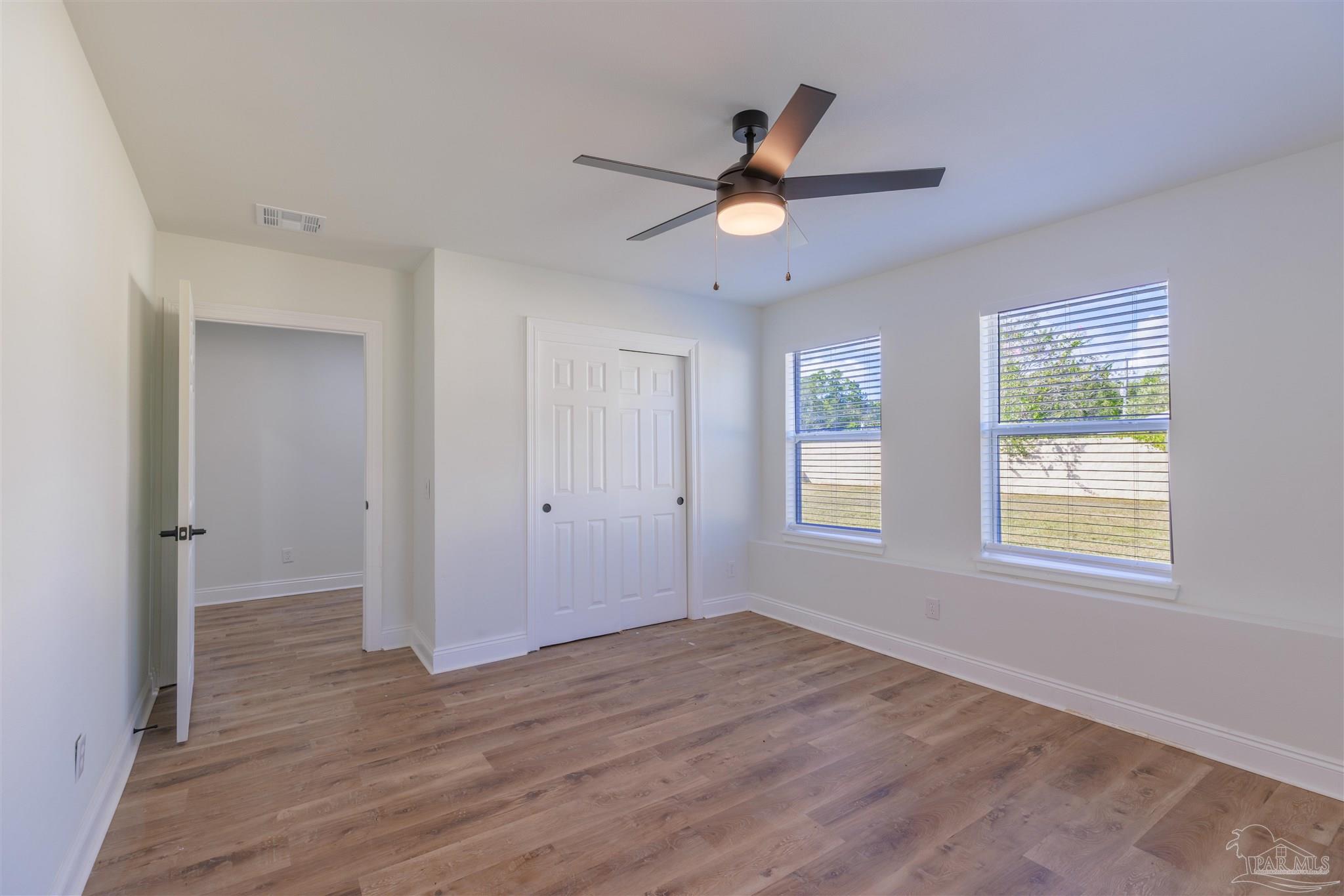 2115 Stallion Road Cantonment, FL 32533 - Photo 45 of 70 a view of empty room with wooden floor and fan