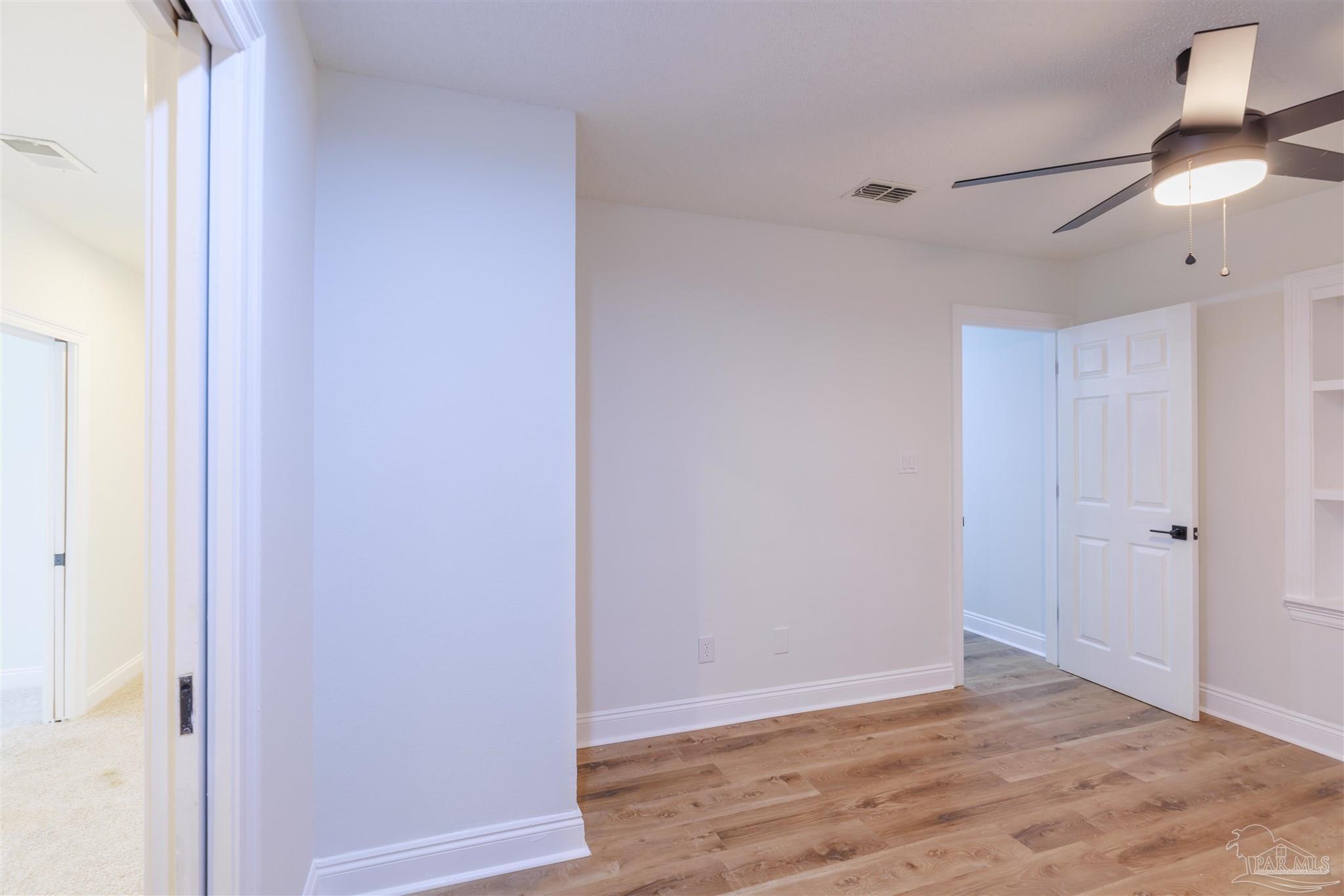 2115 Stallion Road Cantonment, FL 32533 - Photo 49 of 70 a view of an empty room with wooden floor