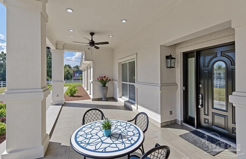 2115 Stallion Road Cantonment, FL 32533 - Photo 5 of 70 a view of a dining room with furniture window and wooden floor