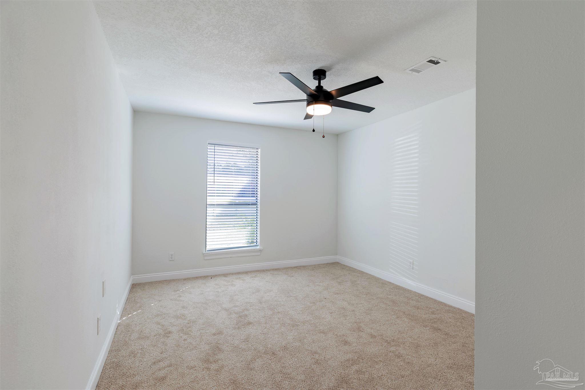 2115 Stallion Road Cantonment, FL 32533 - Photo 56 of 70 an empty room with a window and a fan