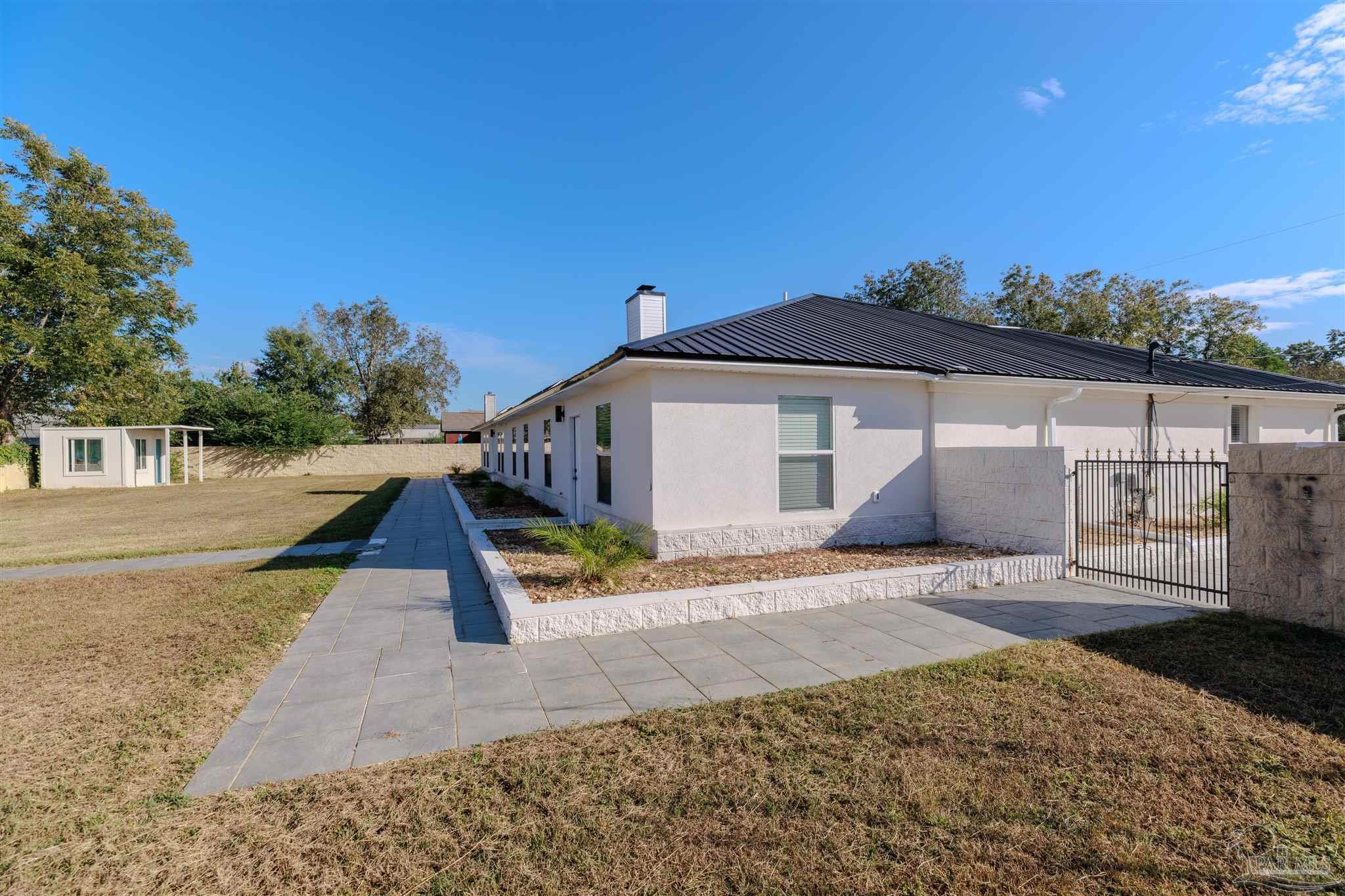 2115 Stallion Road Cantonment, FL 32533 - Photo 67 of 70 a front view of a house with a yard