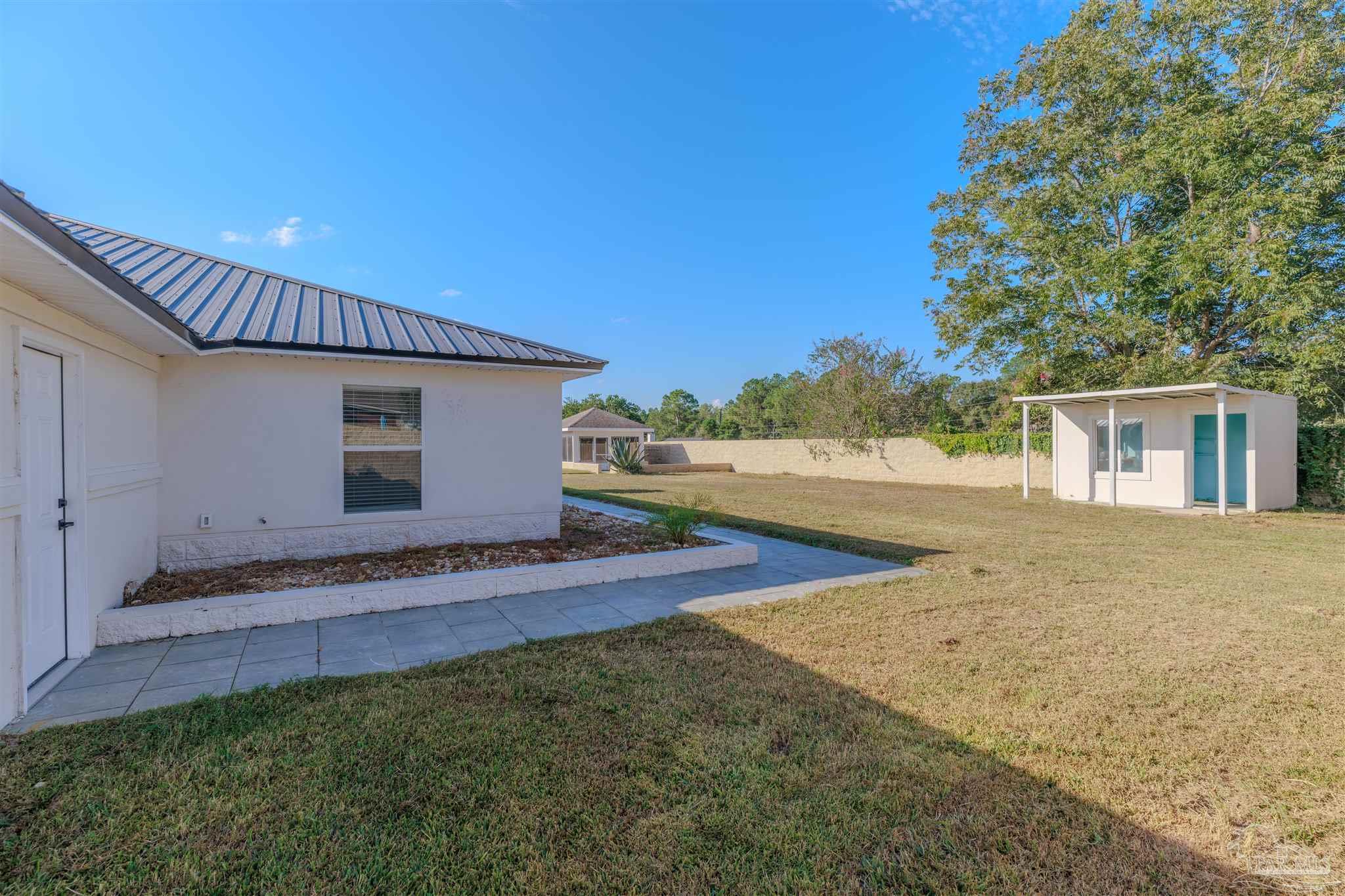 2115 Stallion Road Cantonment, FL 32533 - Photo 68 of 70 a view of a house with backyard and trees