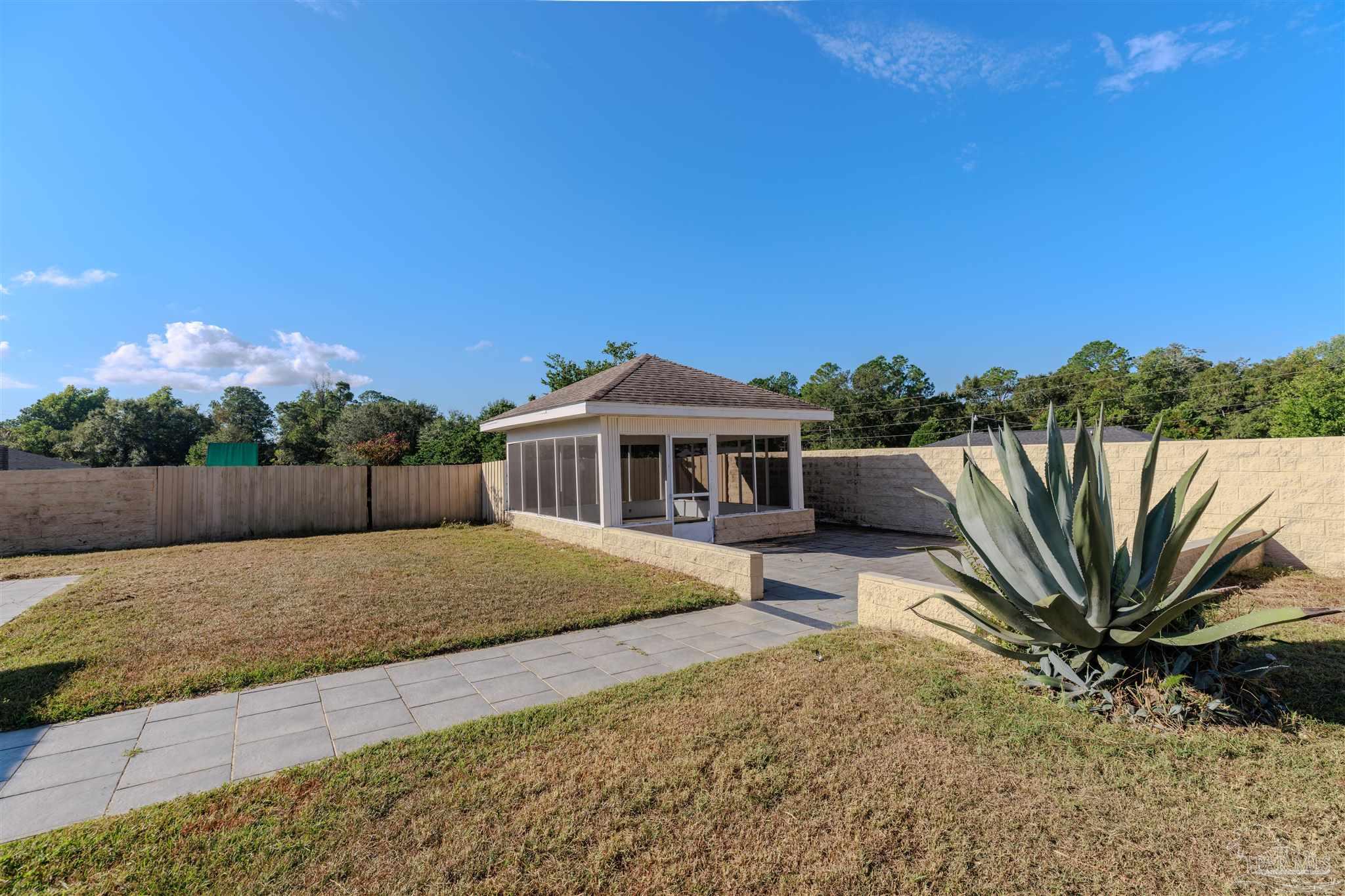2115 Stallion Road Cantonment, FL 32533 - Photo 70 of 70 a house with trees in the background