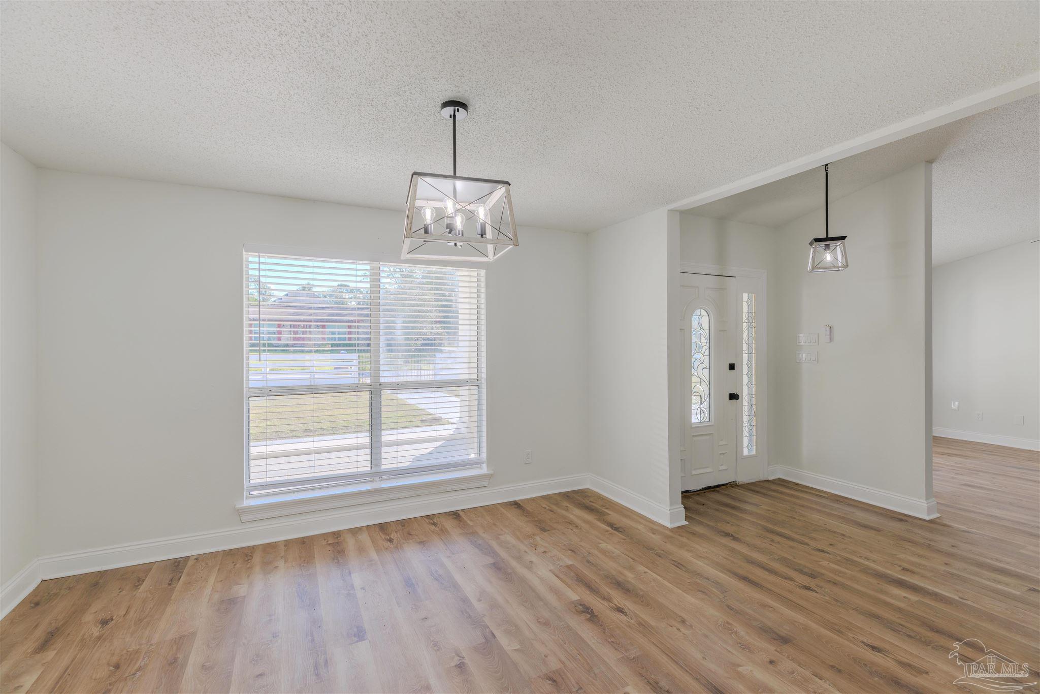 2115 Stallion Road Cantonment, FL 32533 - Photo 10 of 70 a view of empty room with wooden floor fan and window