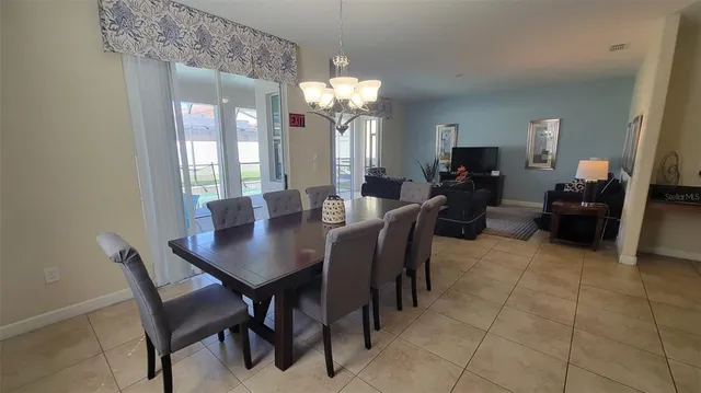 a view of a dining room with furniture and chandelier