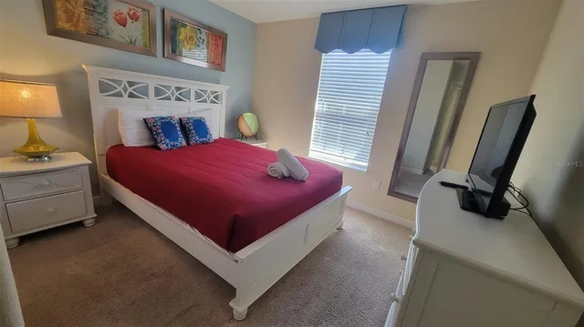 a bed room with a bed and a window