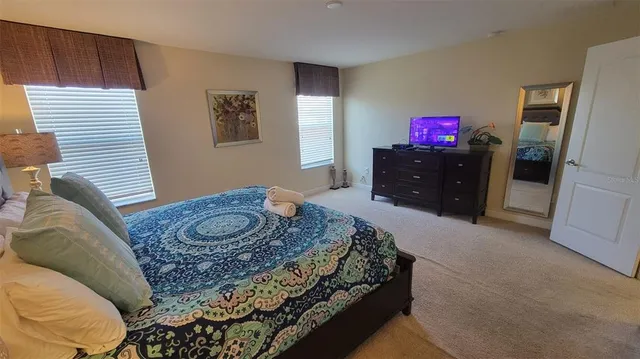 a bedroom with a bed and a dresser in it