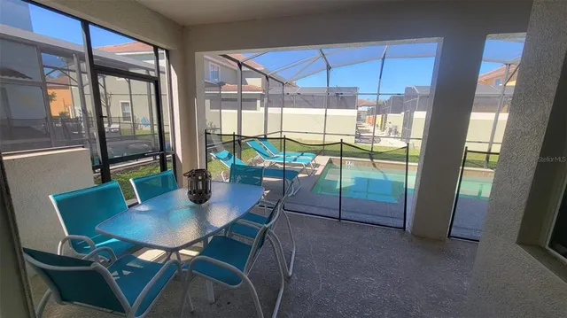 a view of a dining room with furniture and a window