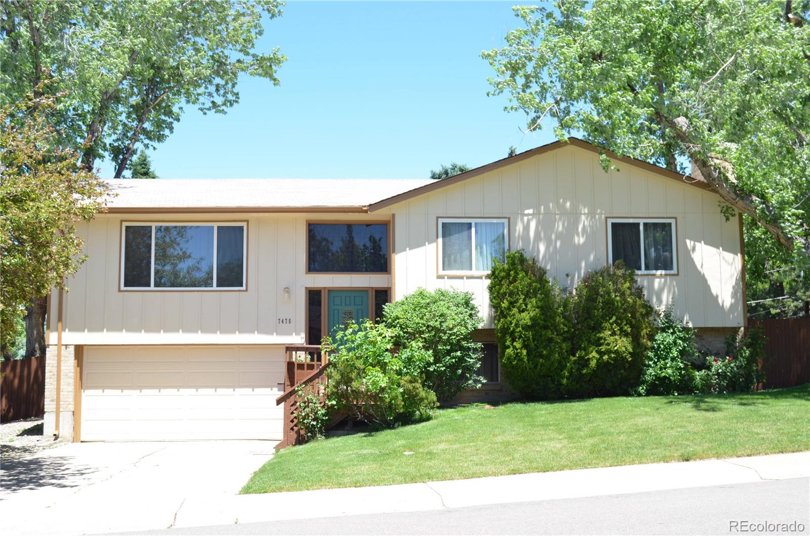 7475 East Davies Court Centennial, CO 80112 - Photo 1 of 23 a view of backyard with potted plants and a tree