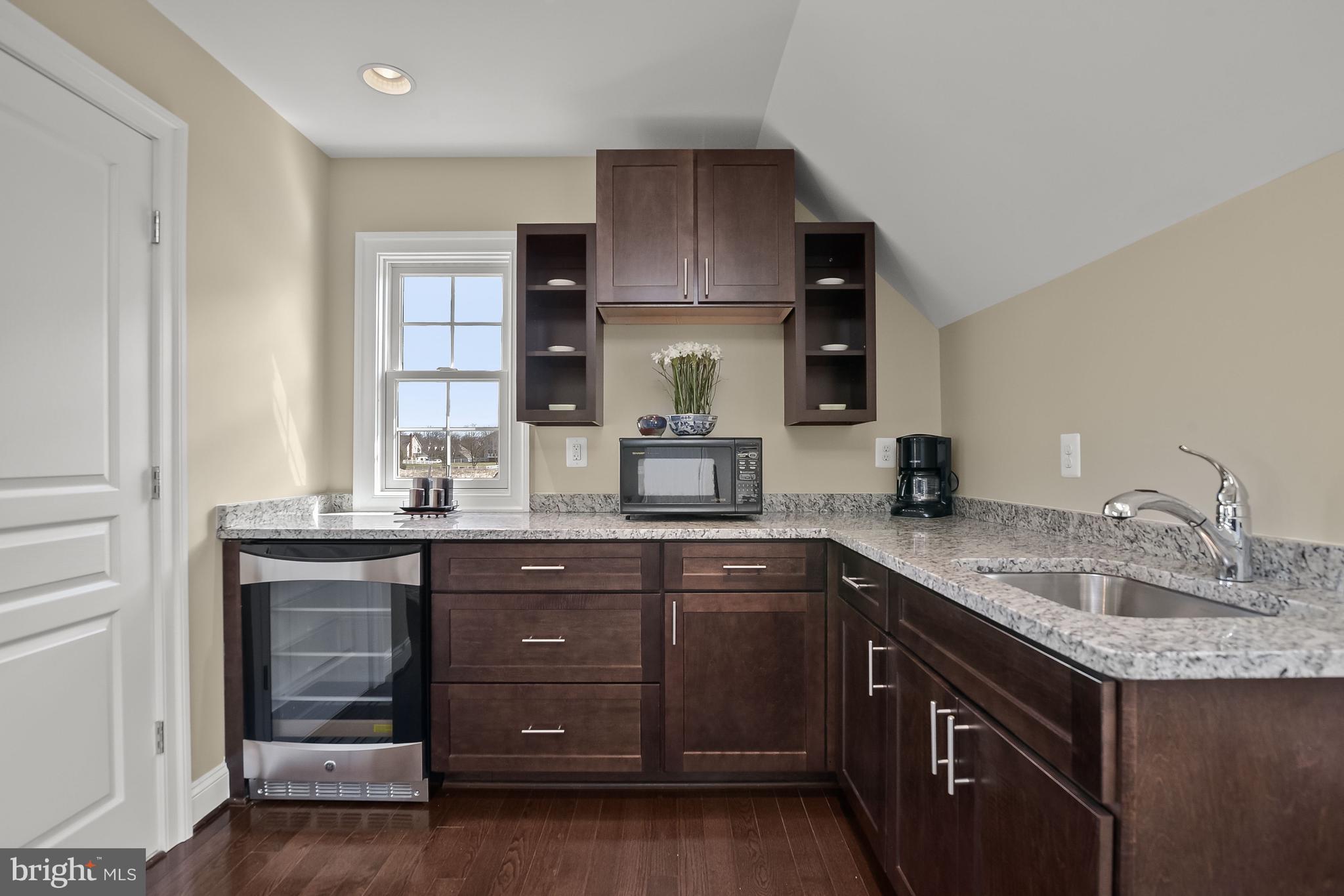 21151 Mill Branch Drive Leesburg, VA 20175 - Photo 108 of 132 a kitchen with a sink cabinets and wooden floor