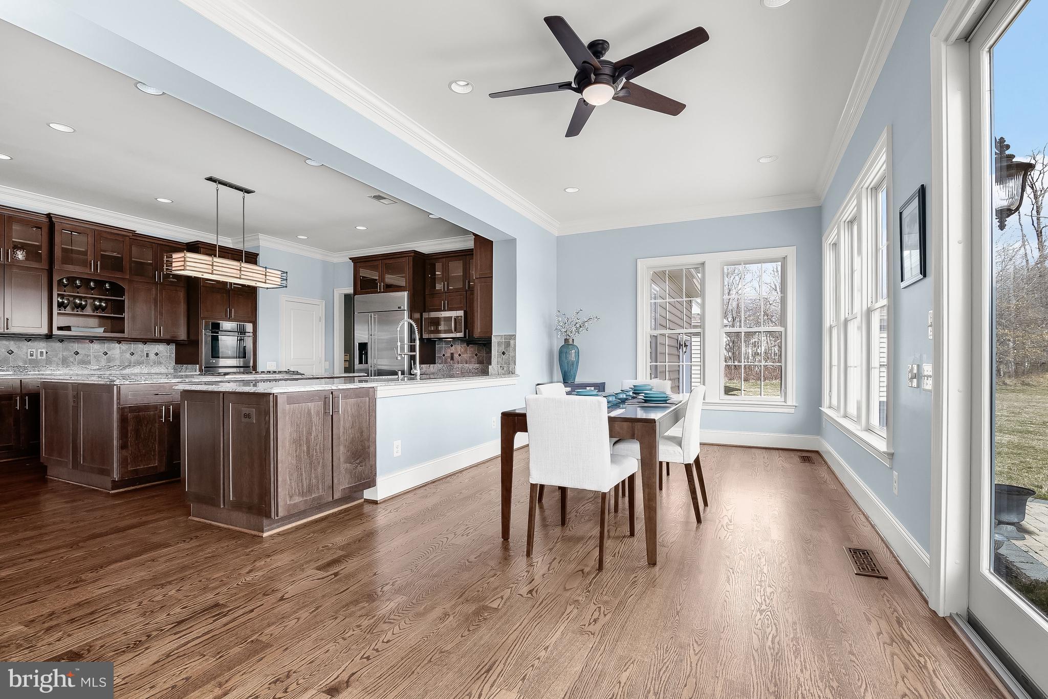 21151 Mill Branch Drive Leesburg, VA 20175 - Photo 34 of 132 a view of a dining room with furniture window and wooden floor