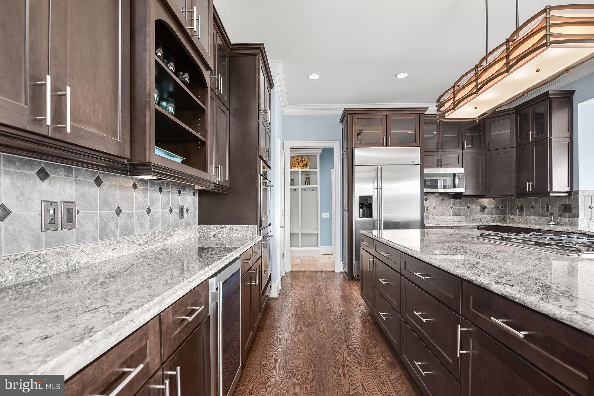 21151 Mill Branch Drive Leesburg, VA 20175 - Photo 42 of 132 a kitchen with stainless steel appliances granite countertop a sink a stove and cabinets