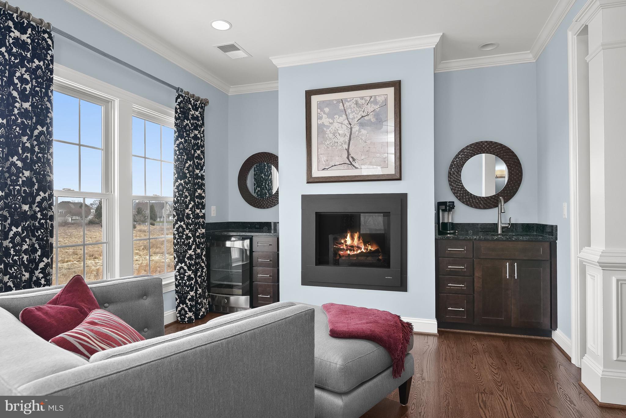 21151 Mill Branch Drive Leesburg, VA 20175 - Photo 52 of 132 a living room with furniture a window and a fireplace
