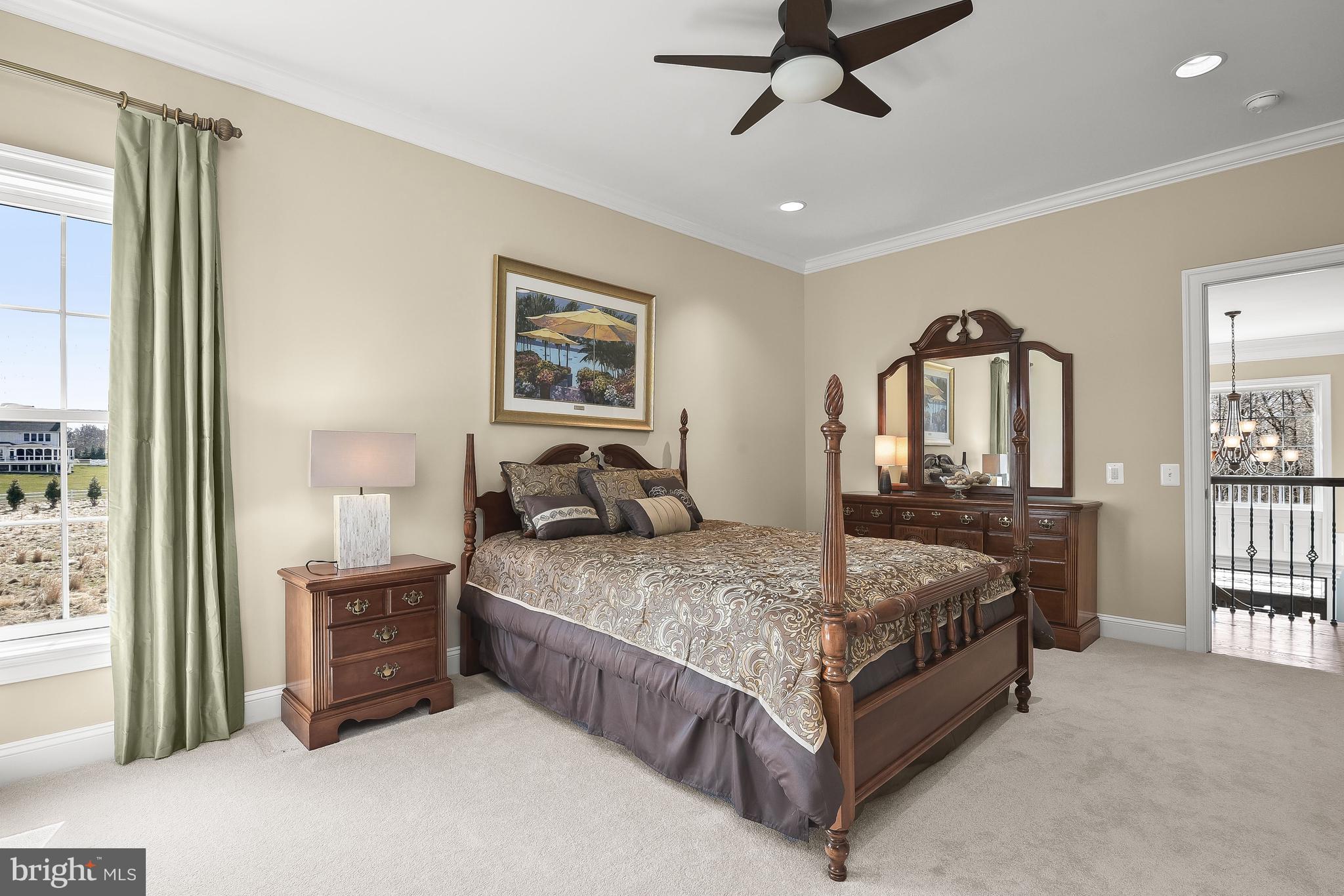 21151 Mill Branch Drive Leesburg, VA 20175 - Photo 65 of 132 a spacious bedroom with a bed a dresser and a window