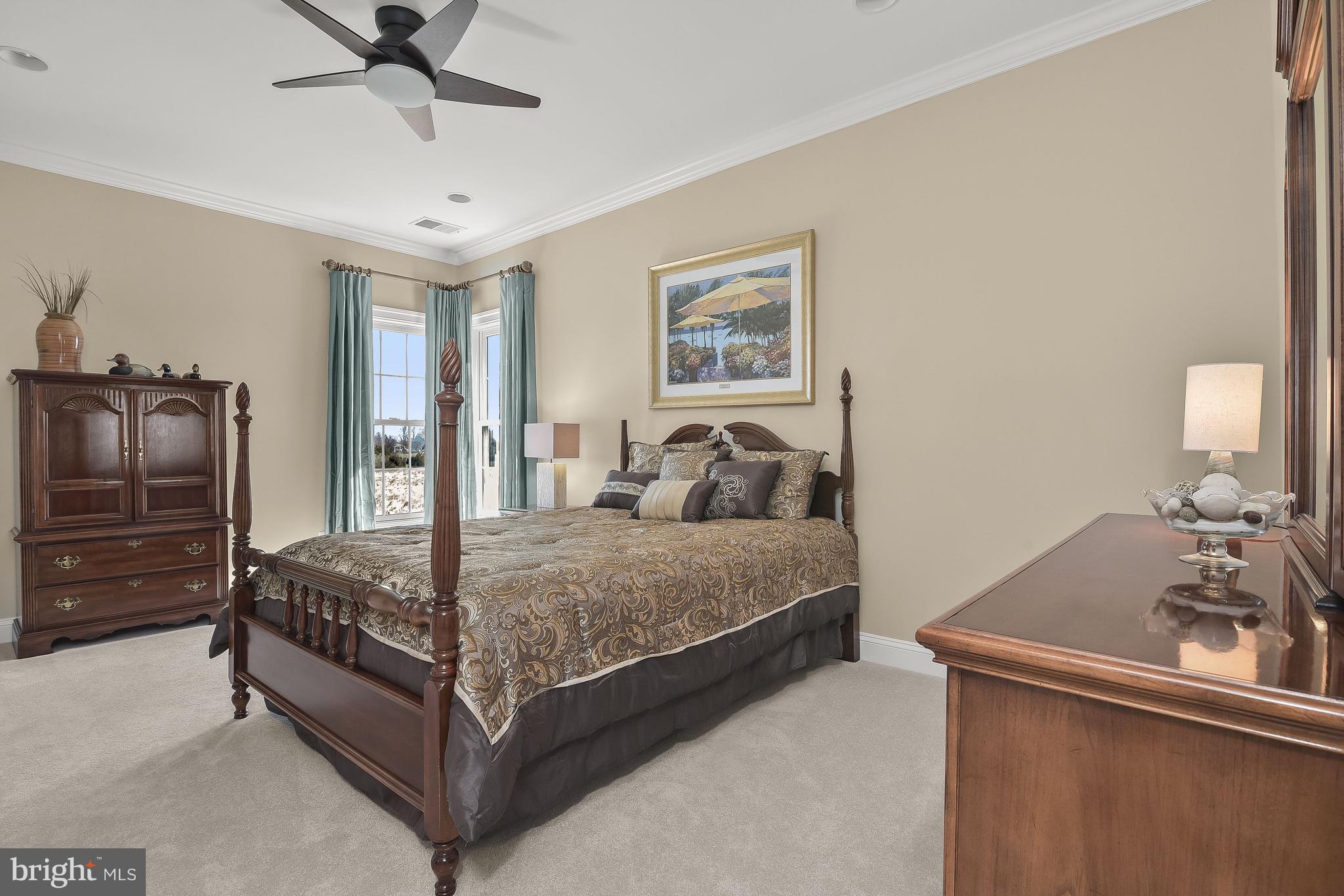 21151 Mill Branch Drive Leesburg, VA 20175 - Photo 66 of 132 a bedroom with a bed and a chandelier
