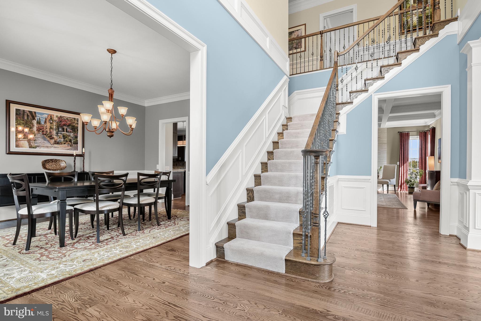 21151 Mill Branch Drive Leesburg, VA 20175 - Photo 74 of 132 a view of a dining room and livingroom with furniture wooden floor a chandelier