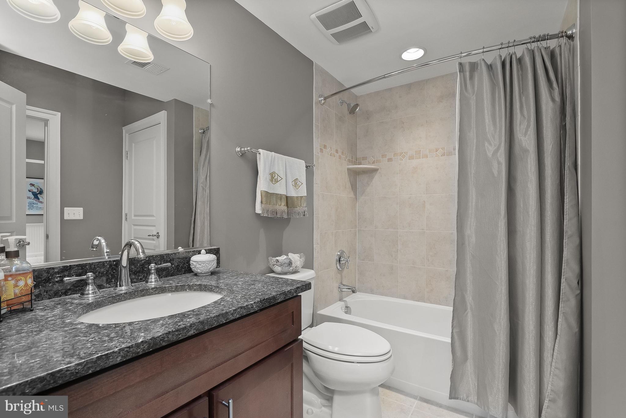 21151 Mill Branch Drive Leesburg, VA 20175 - Photo 84 of 132 a bathroom with a granite countertop sink toilet and shower