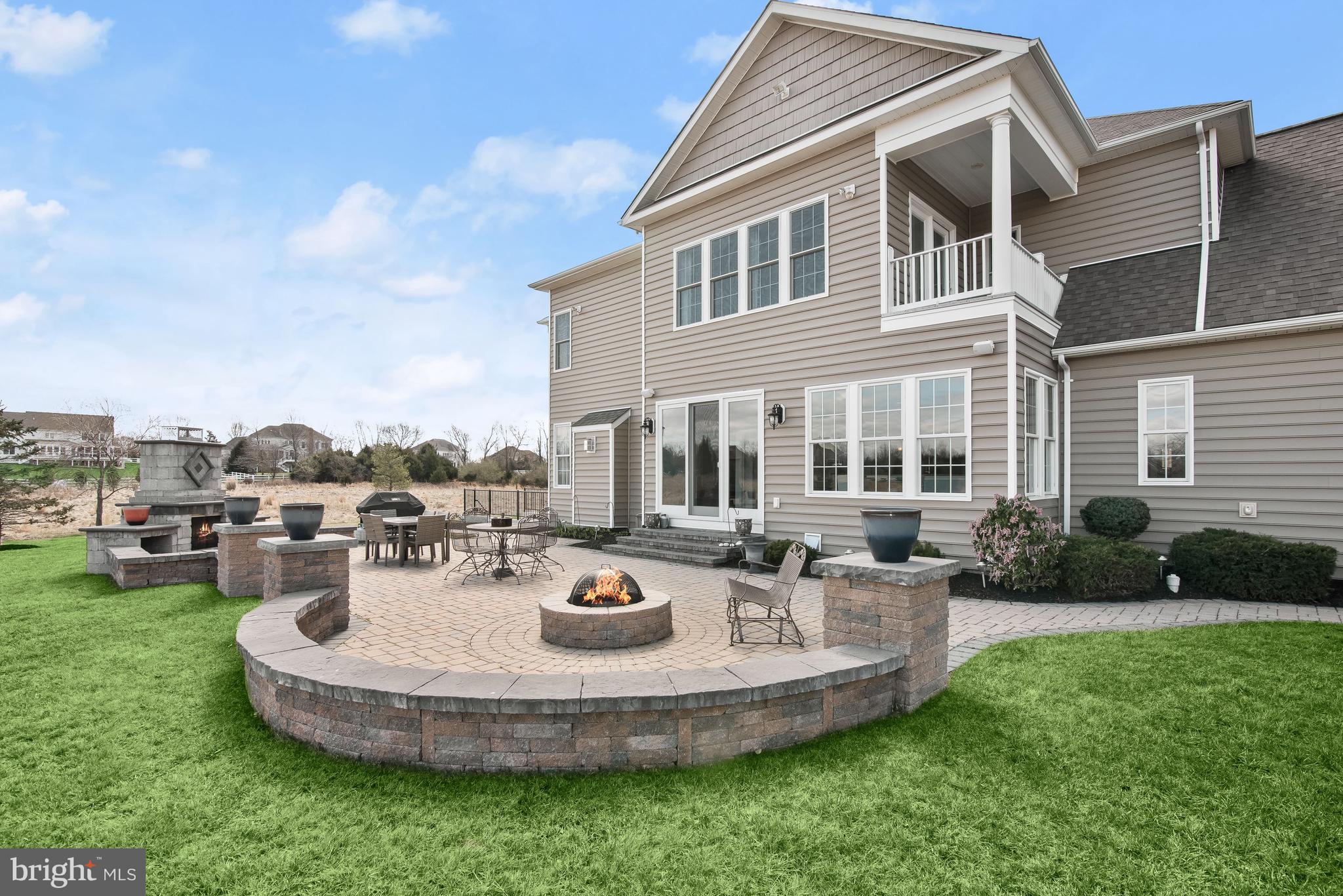 21151 Mill Branch Drive Leesburg, VA 20175 - Photo 95 of 132 a view of a backyard with table and chairs potted plants and a big yard