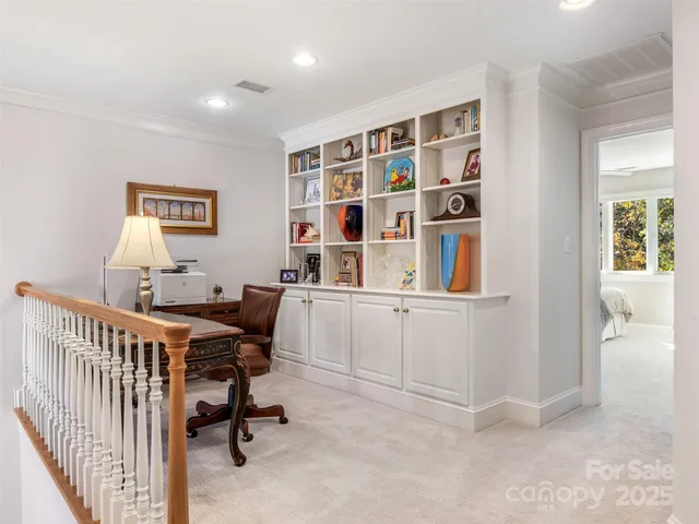 a view of a workspace with furniture and a window