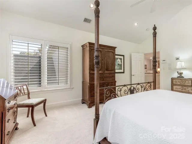 a bed room with a bed and a chair