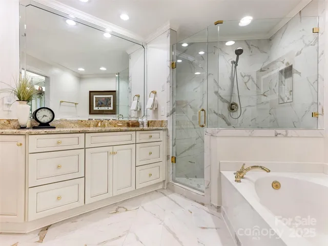 a spacious bathroom with a granite countertop sink mirror and bathtub