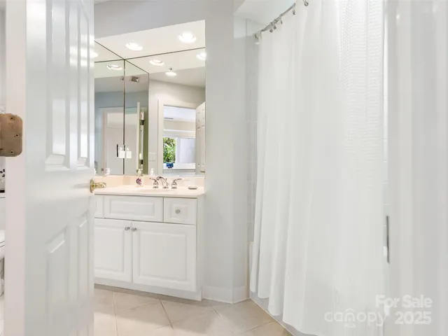 a bathroom with a sink vanity and a mirror