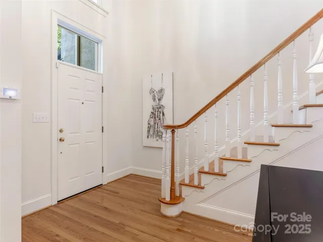 a view of entryway and hall with wooden floor
