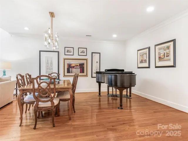 a view of a a dining room with furniture window and wooden floor