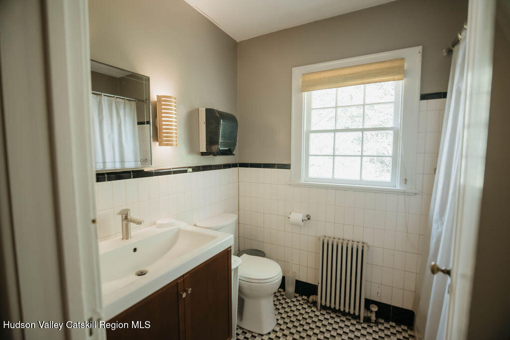 3927 Main Street Stone Ridge, NY 12484 - Photo 20 of 32 a bathroom with a sink toilet and window
