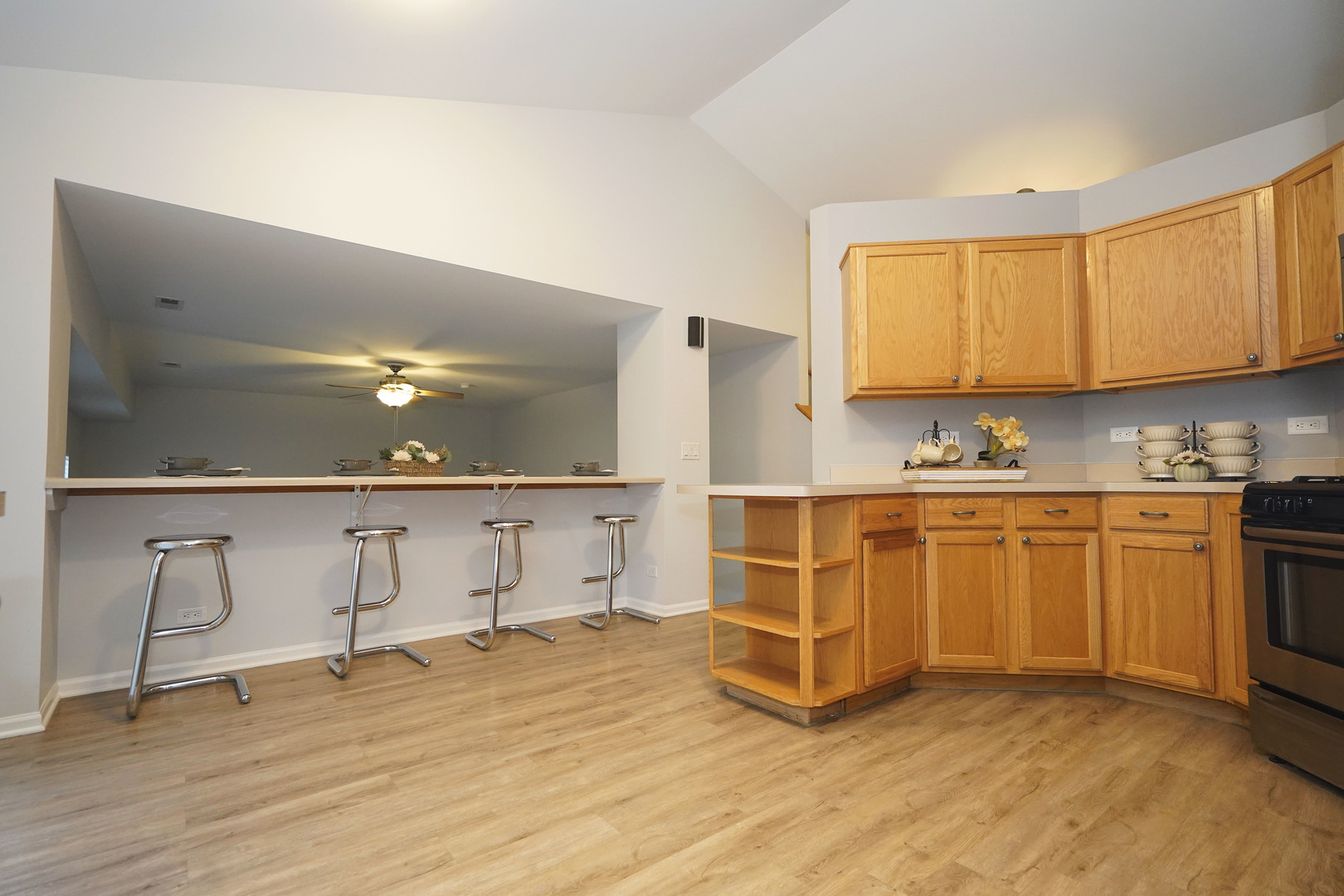 24300 White Oak Drive Plainfield, IL 60585 - Photo 13 of 32 a view of cabinets a sink and a stove in a room