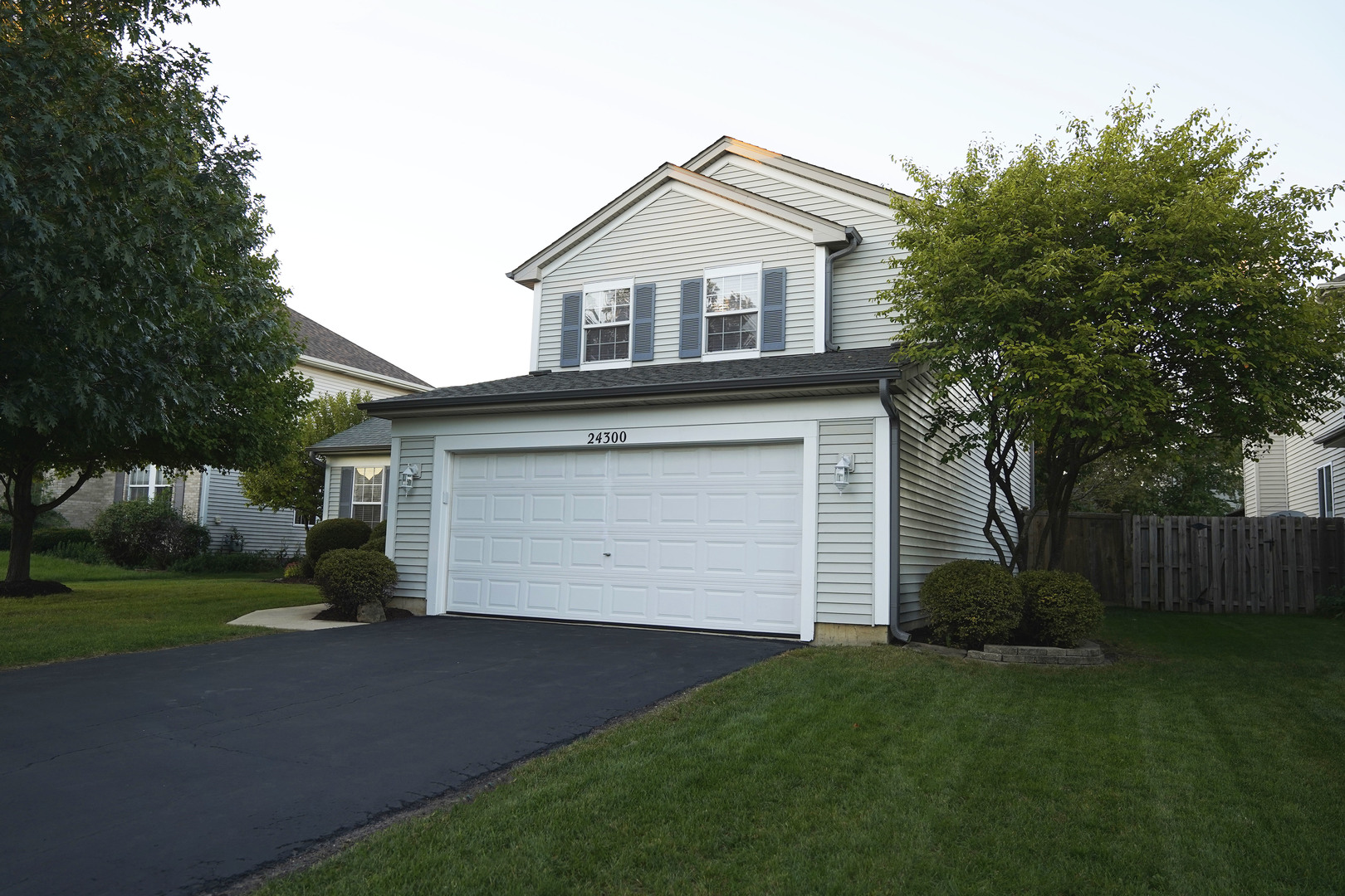 24300 White Oak Drive Plainfield, IL 60585 - Photo 2 of 32 a front view of a house with a garden