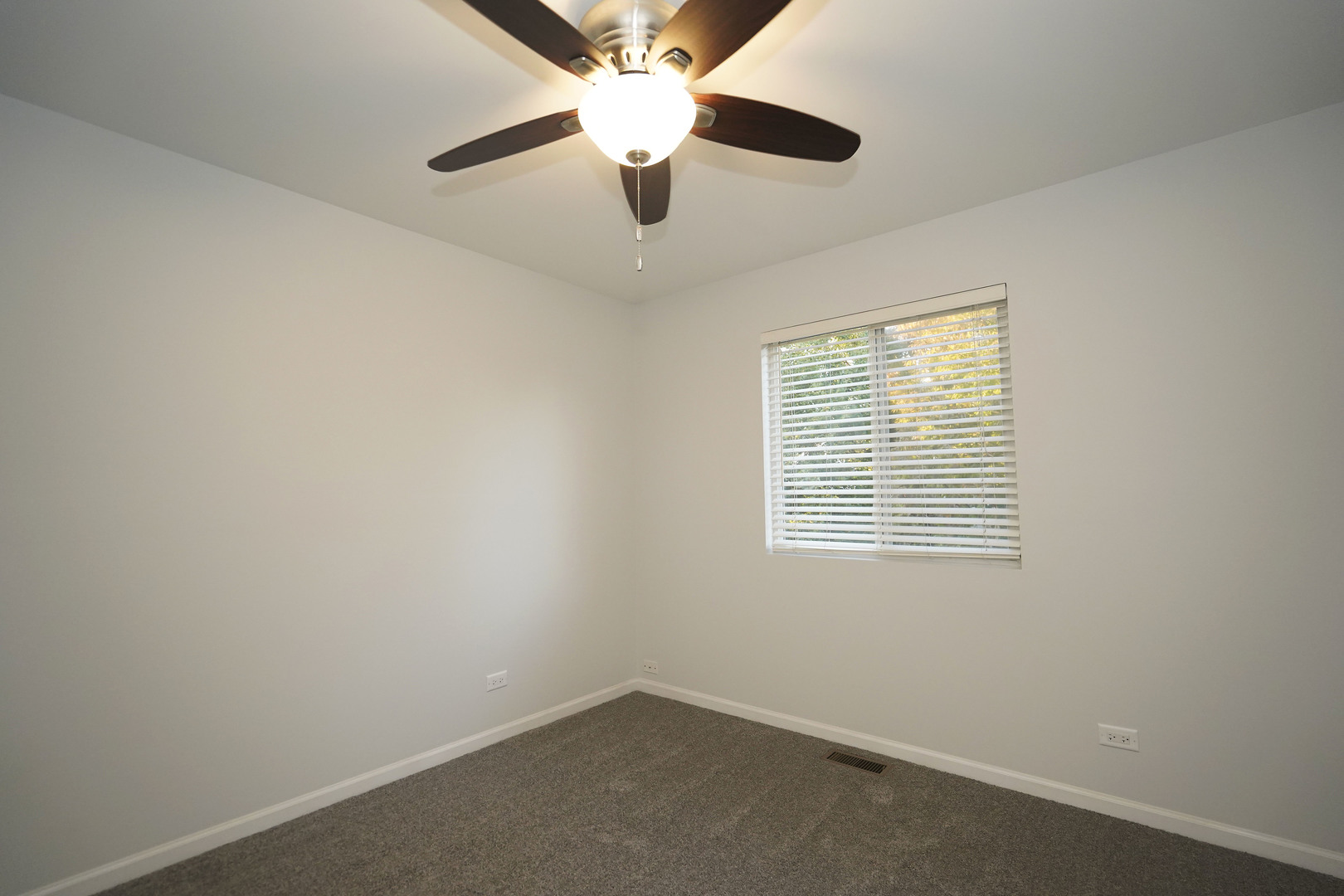 24300 White Oak Drive Plainfield, IL 60585 - Photo 26 of 32 an empty room with a window and a fan