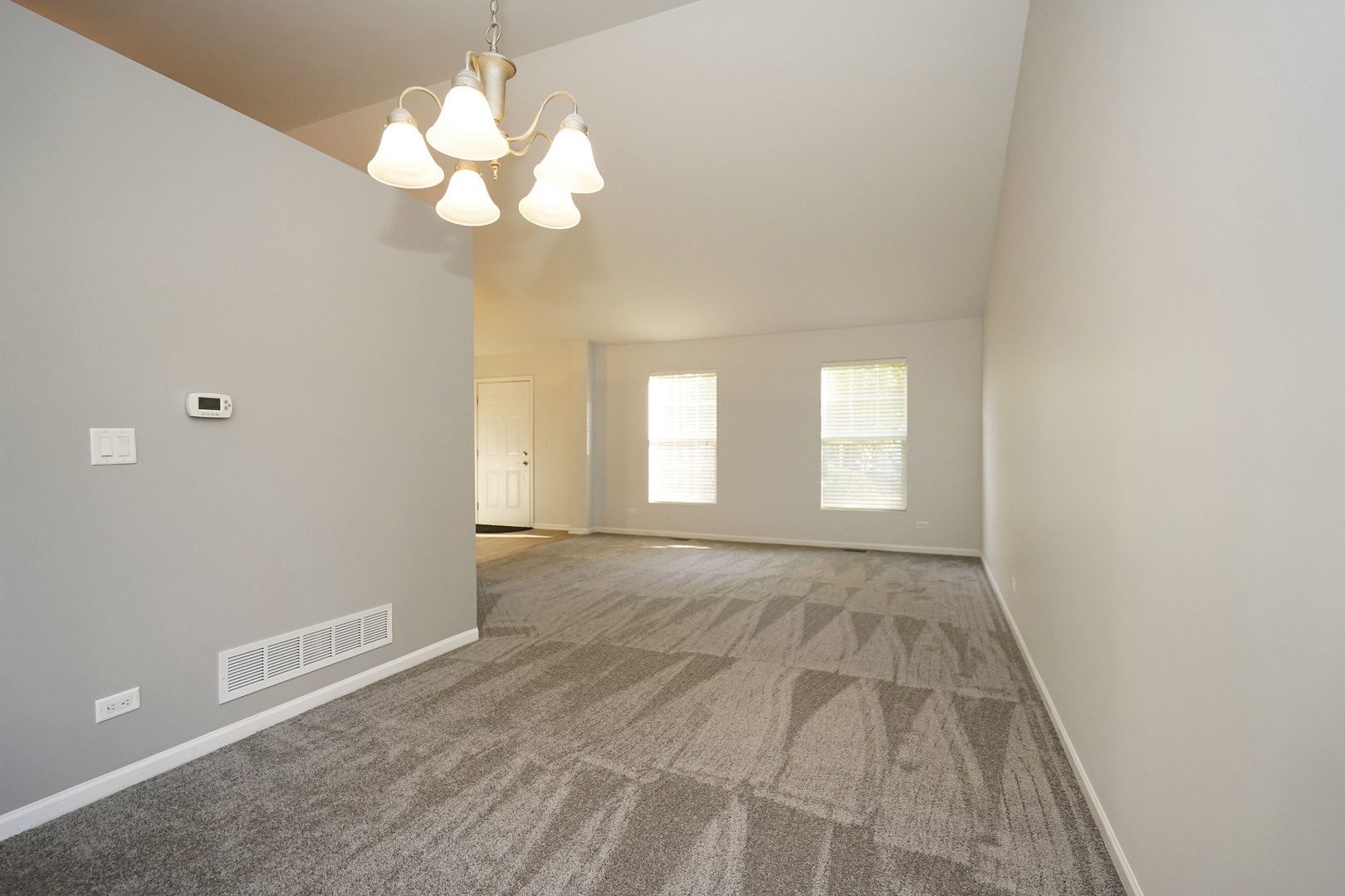 24300 White Oak Drive Plainfield, IL 60585 - Photo 4 of 32 a view of an empty room with wooden floor and a window