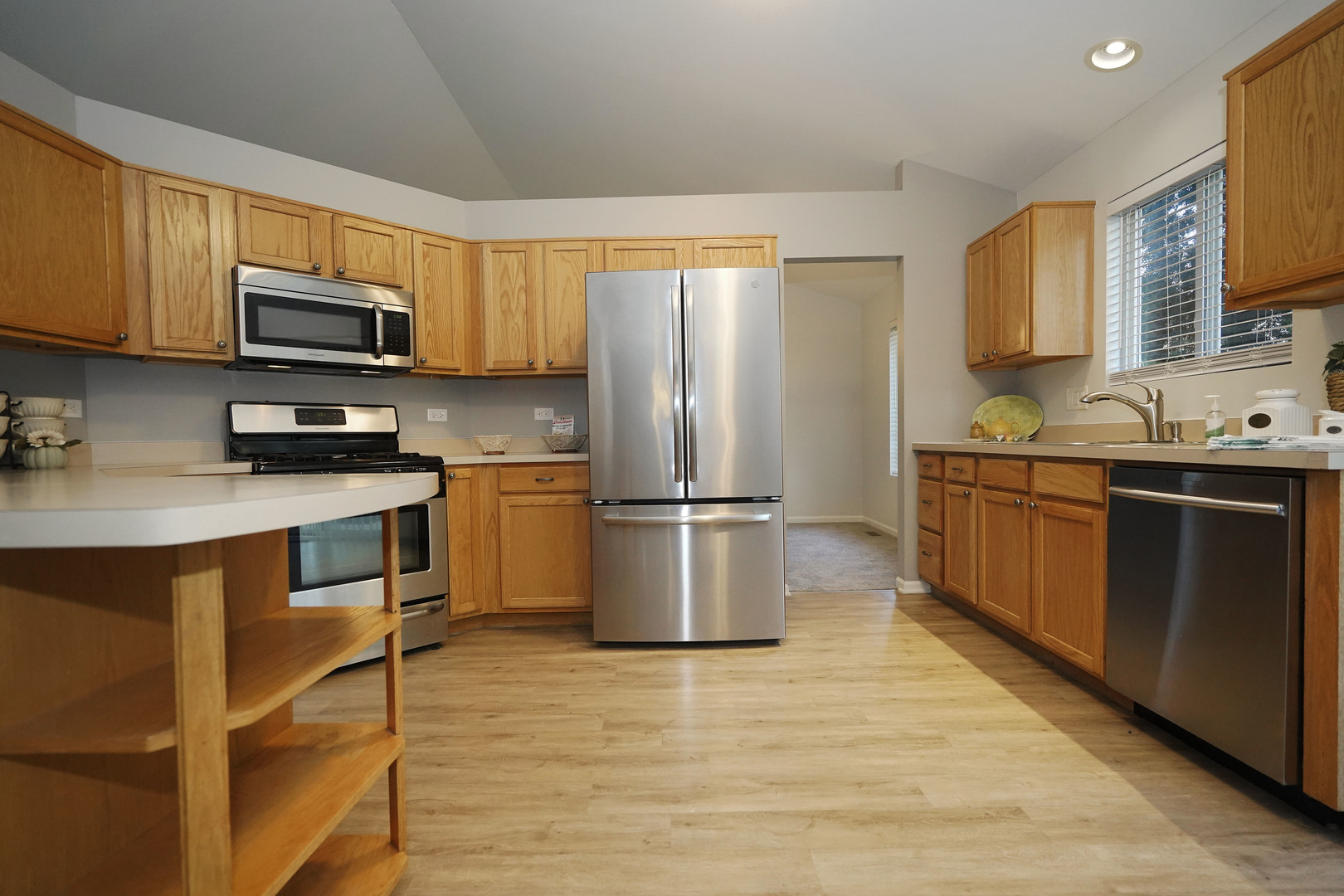 24300 White Oak Drive Plainfield, IL 60585 - Photo 8 of 32 a kitchen with stainless steel appliances a stove a sink a refrigerator a microwave a sink and cabinets