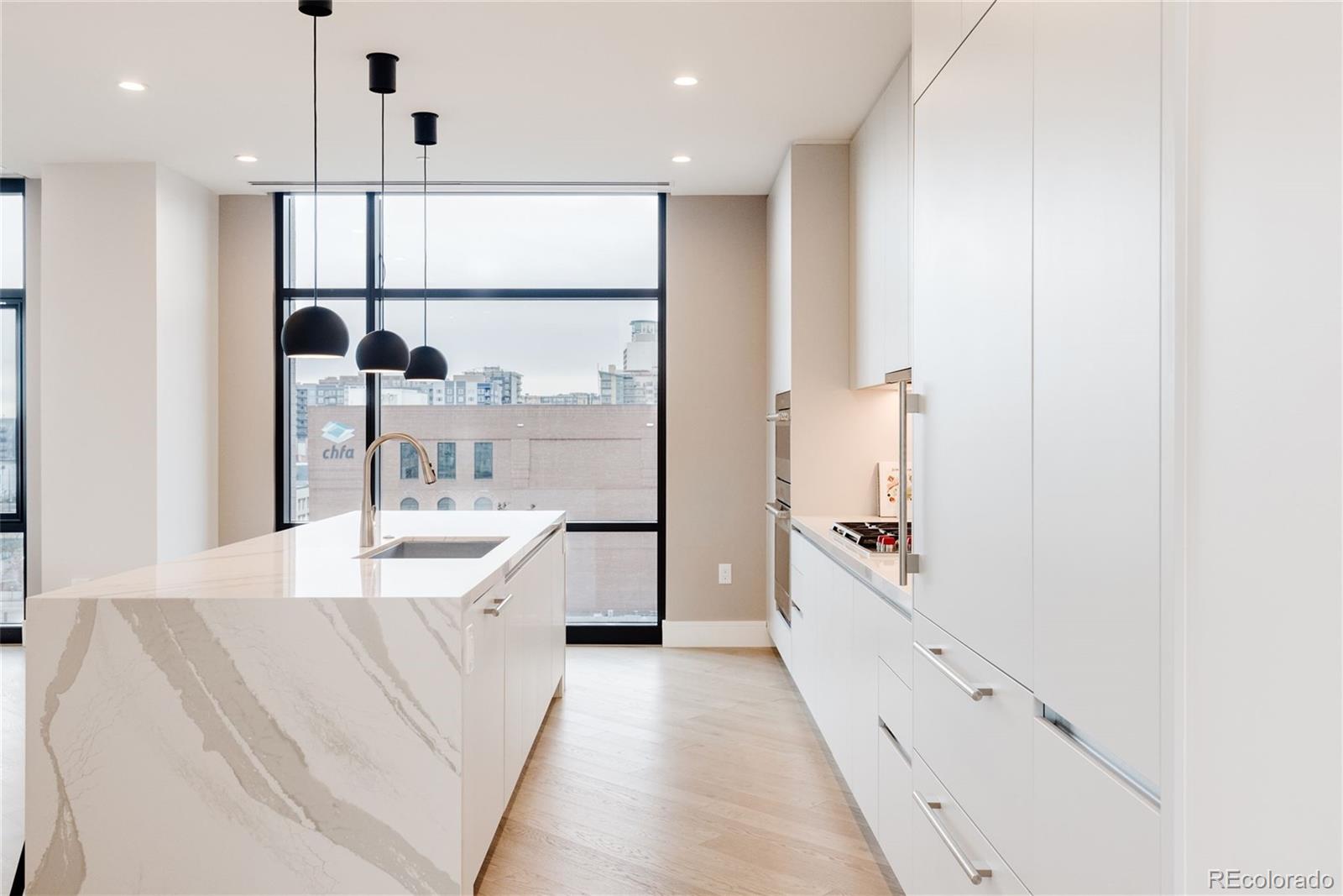 1901 Wazee Street, Unit 720 Denver, CO 80202 - Photo 12 of 40 a large white kitchen with a large window