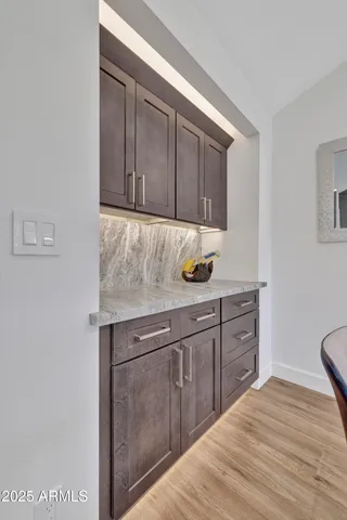 a kitchen with stainless steel appliances granite countertop a sink a stove and a refrigerator