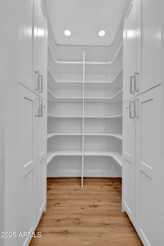 a large bathroom with a granite countertop sink a toilet a large mirror and shower