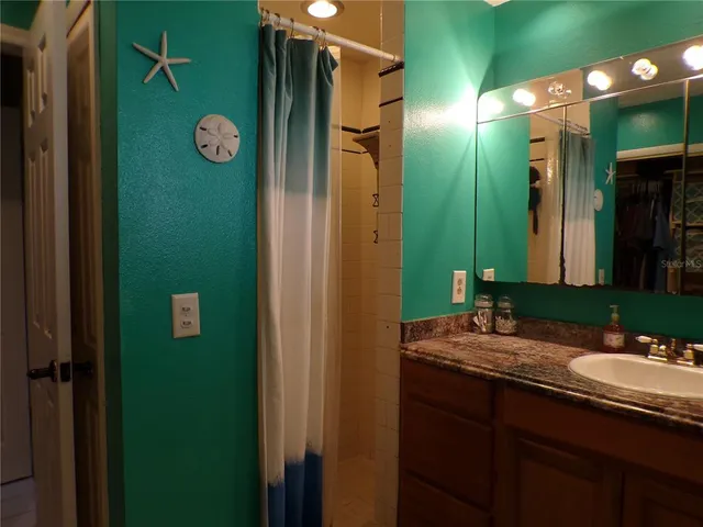 a view of a house with swimming pool and sitting area