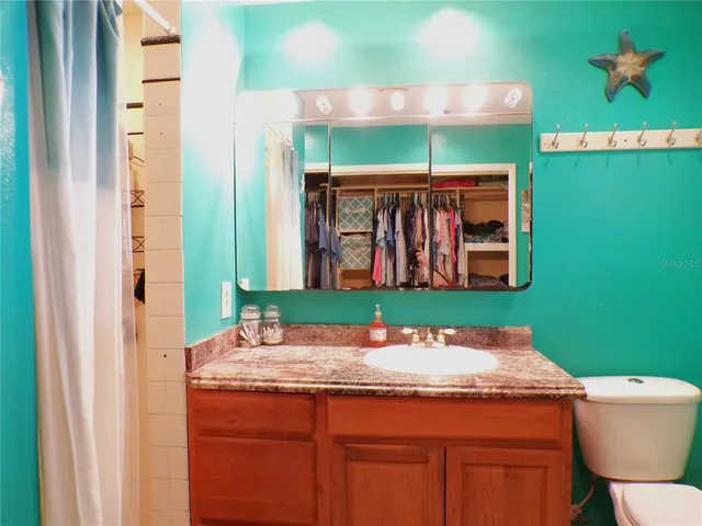 a view of an house with swimming pool and porch with furniture