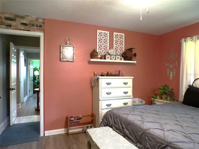 a view of a backyard with table and chairs and a large tree