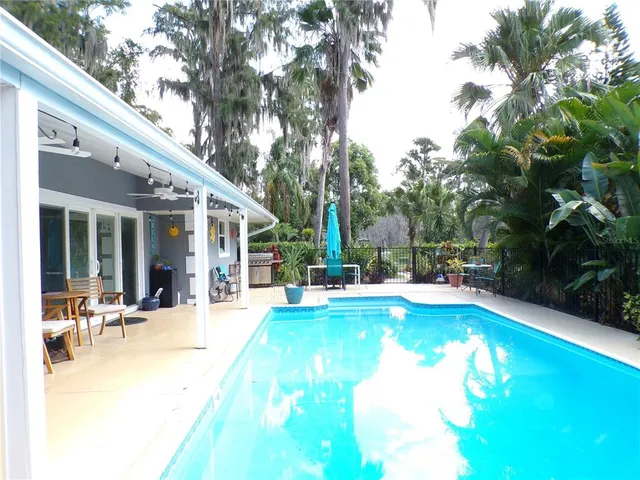 a view of house with garden and a sitting area