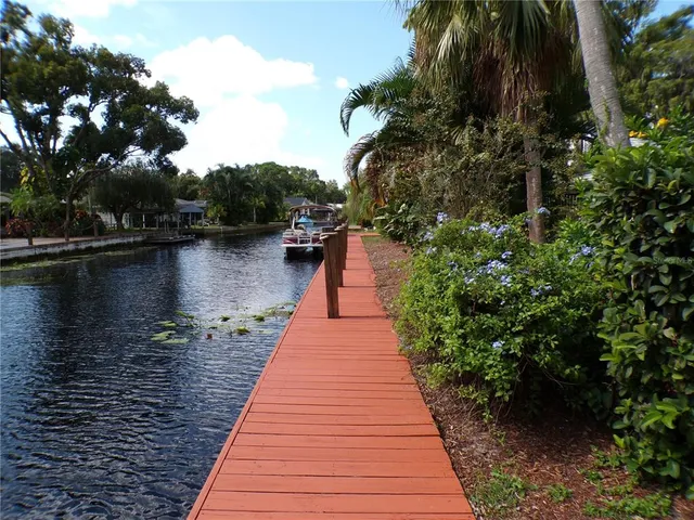 a view of a house with patio outdoor space and lake view